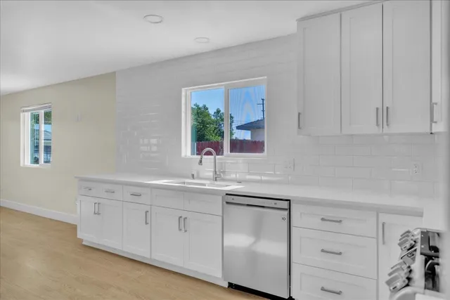 a kitchen with white cabinets