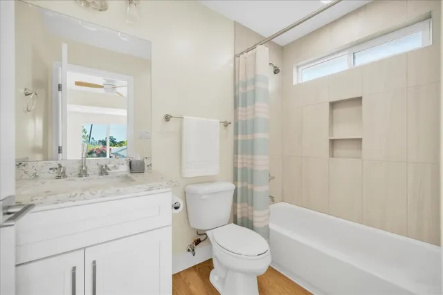 a bathroom with a sink toilet a mirror a bathtub and shower