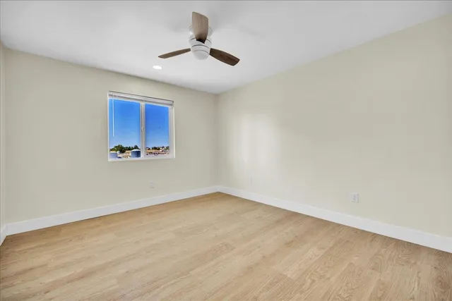 an empty room with a empty space and a ceiling fan