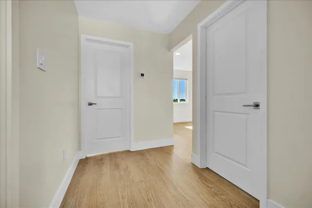 a view of a hallway with wooden floor