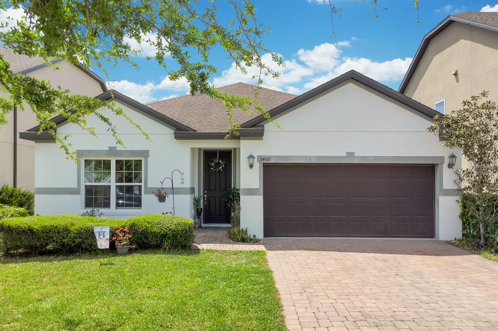 3468 Middlebrook Place St. Cloud, FL 34773 - Photo 1 of 32 a front view of a house with a garden and yard