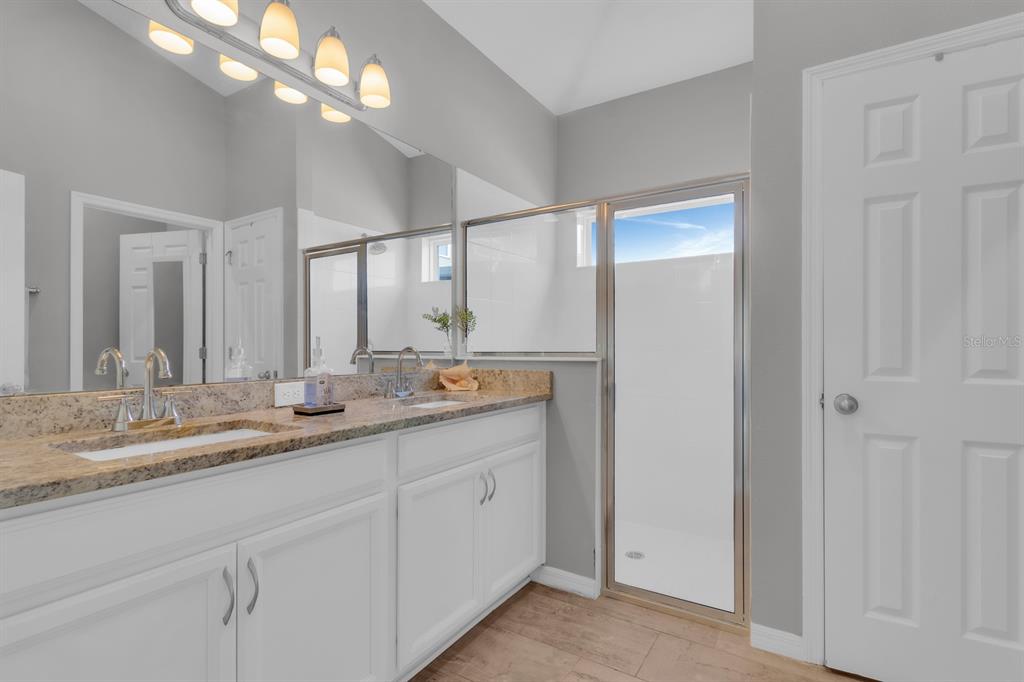 3468 Middlebrook Place St. Cloud, FL 34773 - Photo 13 of 32 a bathroom with a double vanity sink and a mirror