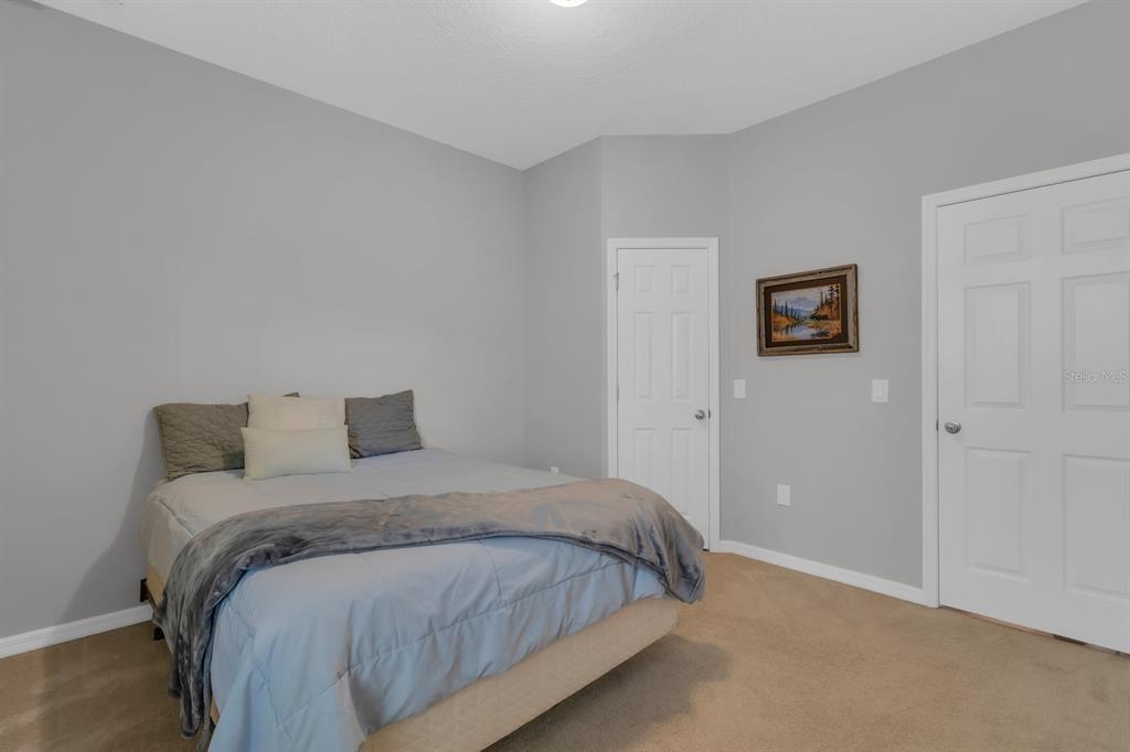 3468 Middlebrook Place St. Cloud, FL 34773 - Photo 16 of 32 a bed sitting in a bedroom next to a bathroom