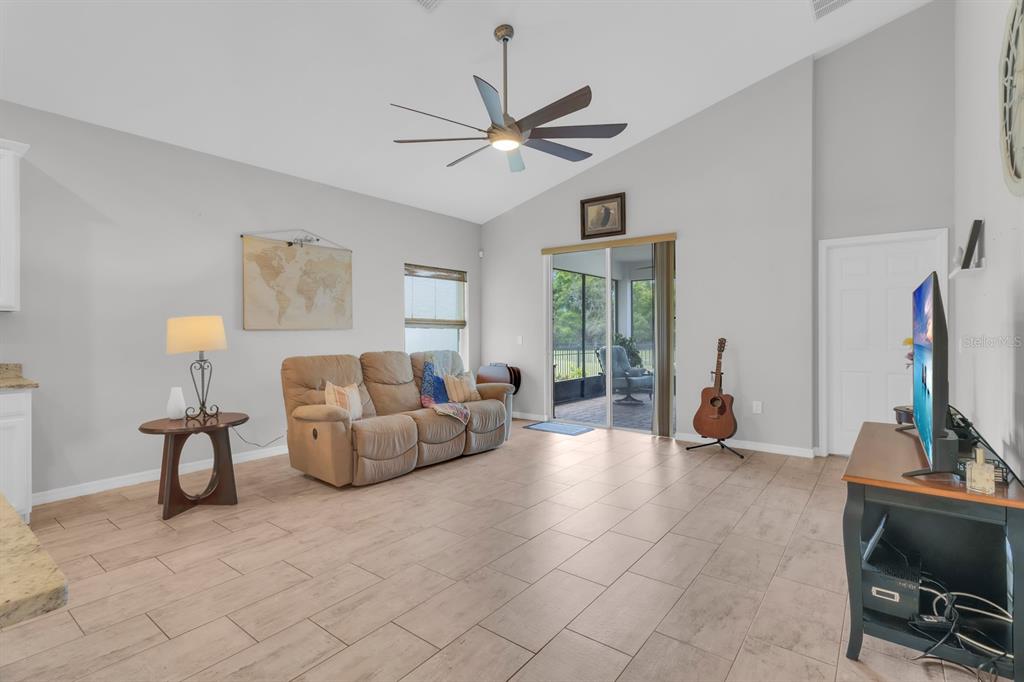 3468 Middlebrook Place St. Cloud, FL 34773 - Photo 10 of 32 a living room with furniture a chandelier fan and a large window