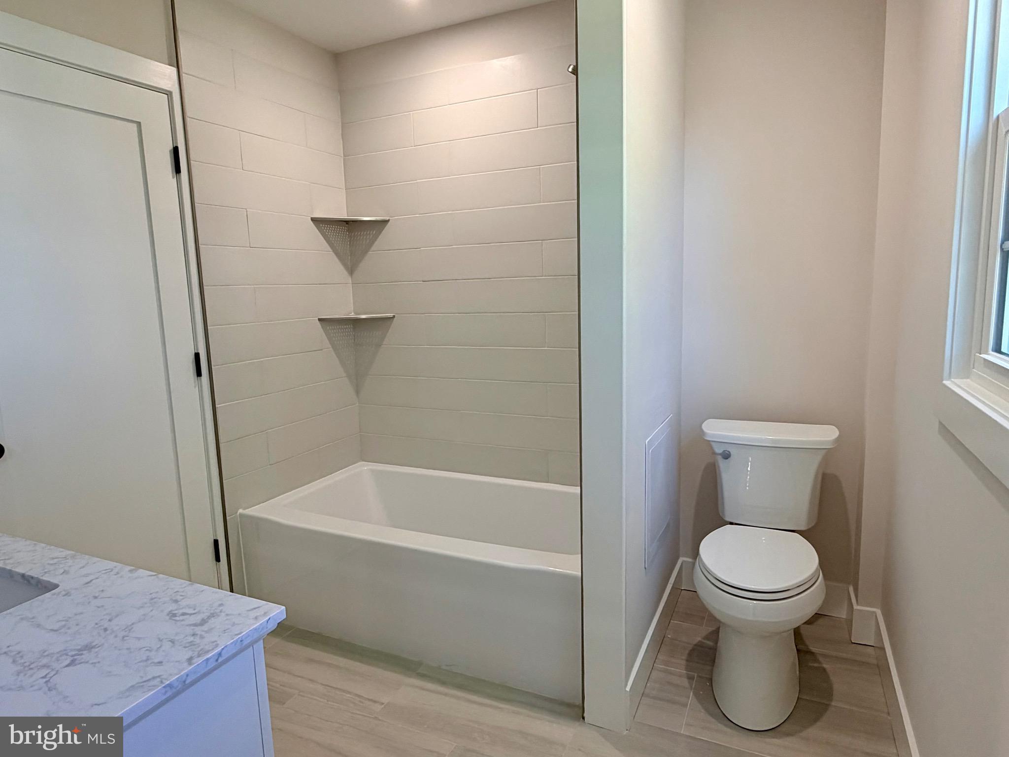 31 Berkley Road Broomall, PA 19008 - Photo 23 of 33 a bathroom with a granite countertop toilet a sink and bathtub