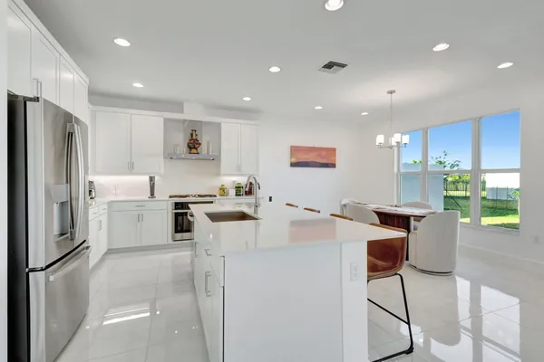 a kitchen with white cabinets and stainless steel appliances