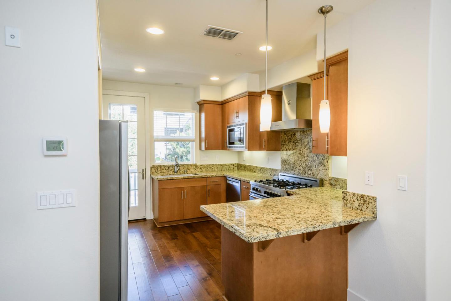 2912 Shoemaker Dr. San Mateo, CA 94403 - Photo 5 of 27 a kitchen with a sink a stove a refrigerator and wooden cabinets