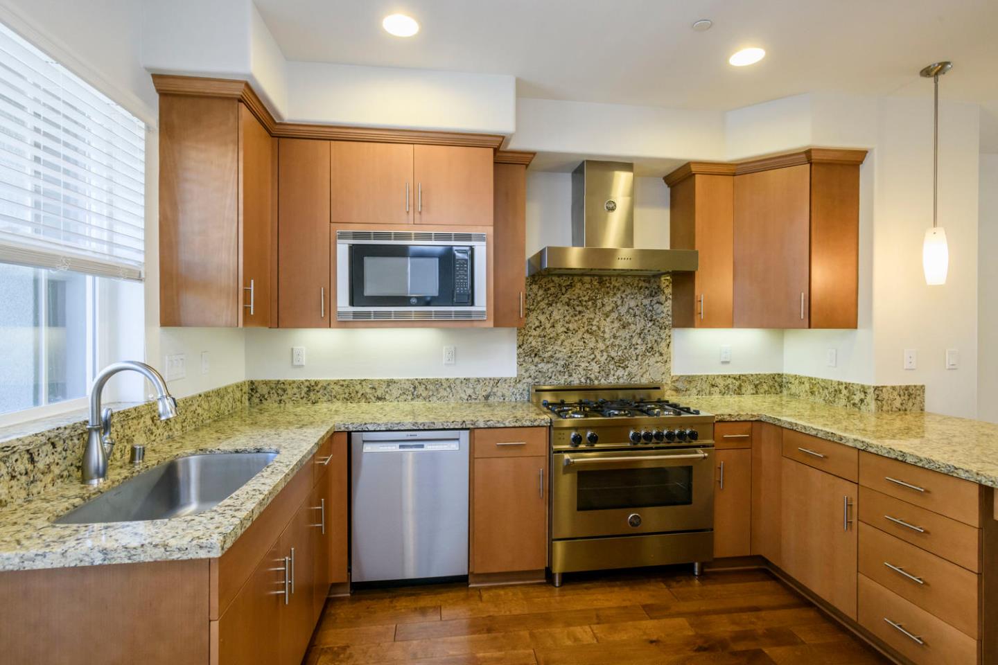 2912 Shoemaker Dr. San Mateo, CA 94403 - Photo 7 of 27 a kitchen with granite countertop a sink stove and cabinets