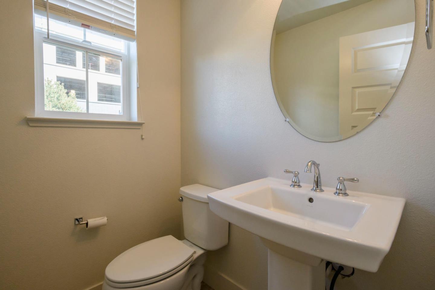2912 Shoemaker Dr. San Mateo, CA 94403 - Photo 9 of 27 a bathroom with a sink a toilet and a mirror