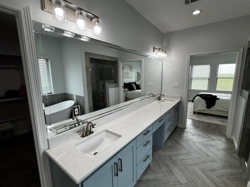 2295 Diamond D Lane Beaumont, TX 77713 - Photo 14 of 40 a bathroom with a double vanity sink and a mirror