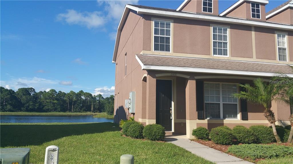 11651 Declaration Drive Tampa, FL 33635 - Photo 1 of 1 Front of Unit showing space between buildings and beautiful view of the lake!