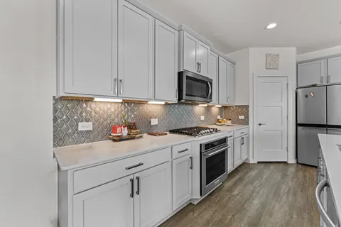 a kitchen with a sink a stove and refrigerator