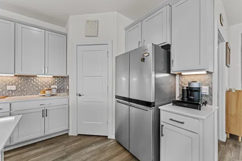 a kitchen with a refrigerator sink and cabinets