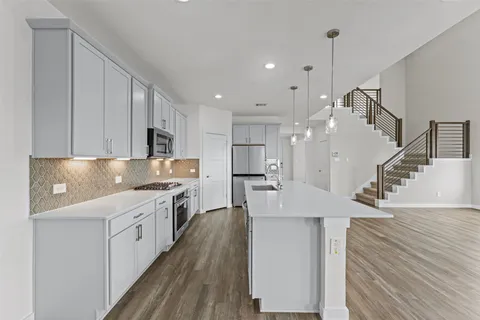 a spacious bathroom with a double vanity sink and a mirror