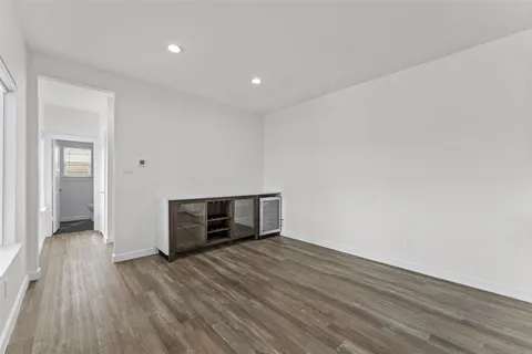 a view of walk in closet with empty racks