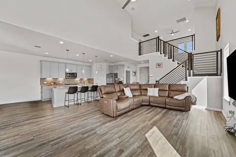 a living room with furniture and wooden floor
