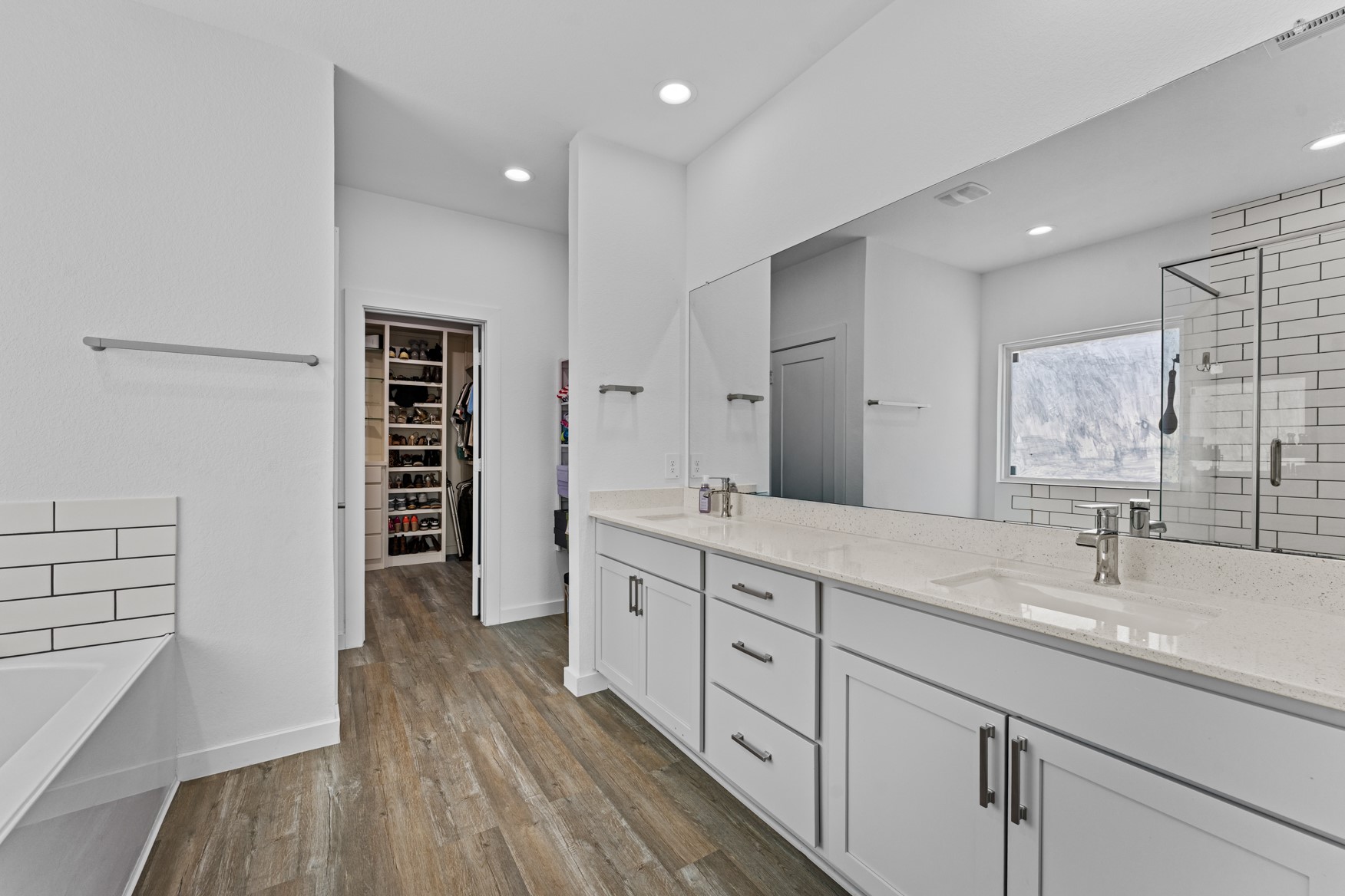 22503 Modica Rift Lane Katy, TX 77449 - Photo 20 of 42 a spacious bathroom with a shower a sink and a large mirror