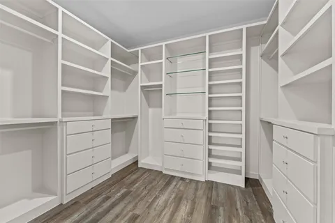 an empty room with a window and a ceiling fan