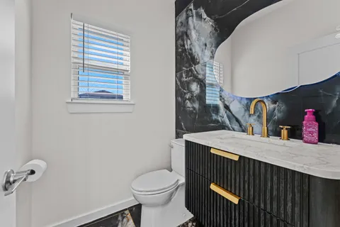a bathroom with a sink toilet and mirror