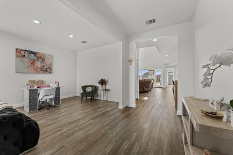 a living room with furniture and a wooden floor