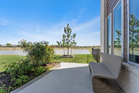 a view of a chairs and table in patio with potted plants