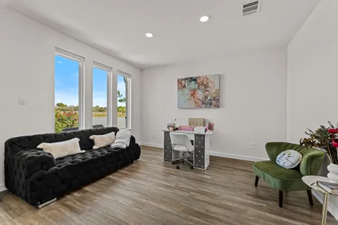 a living room with furniture and wooden floor