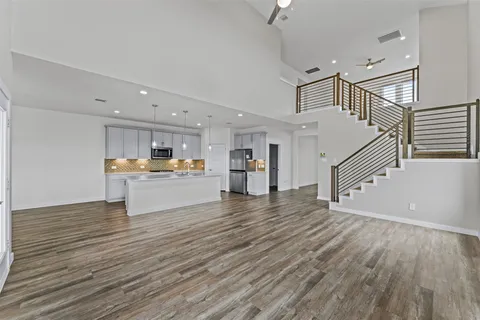 a view of kitchen with kitchen island and stainless steel appliances