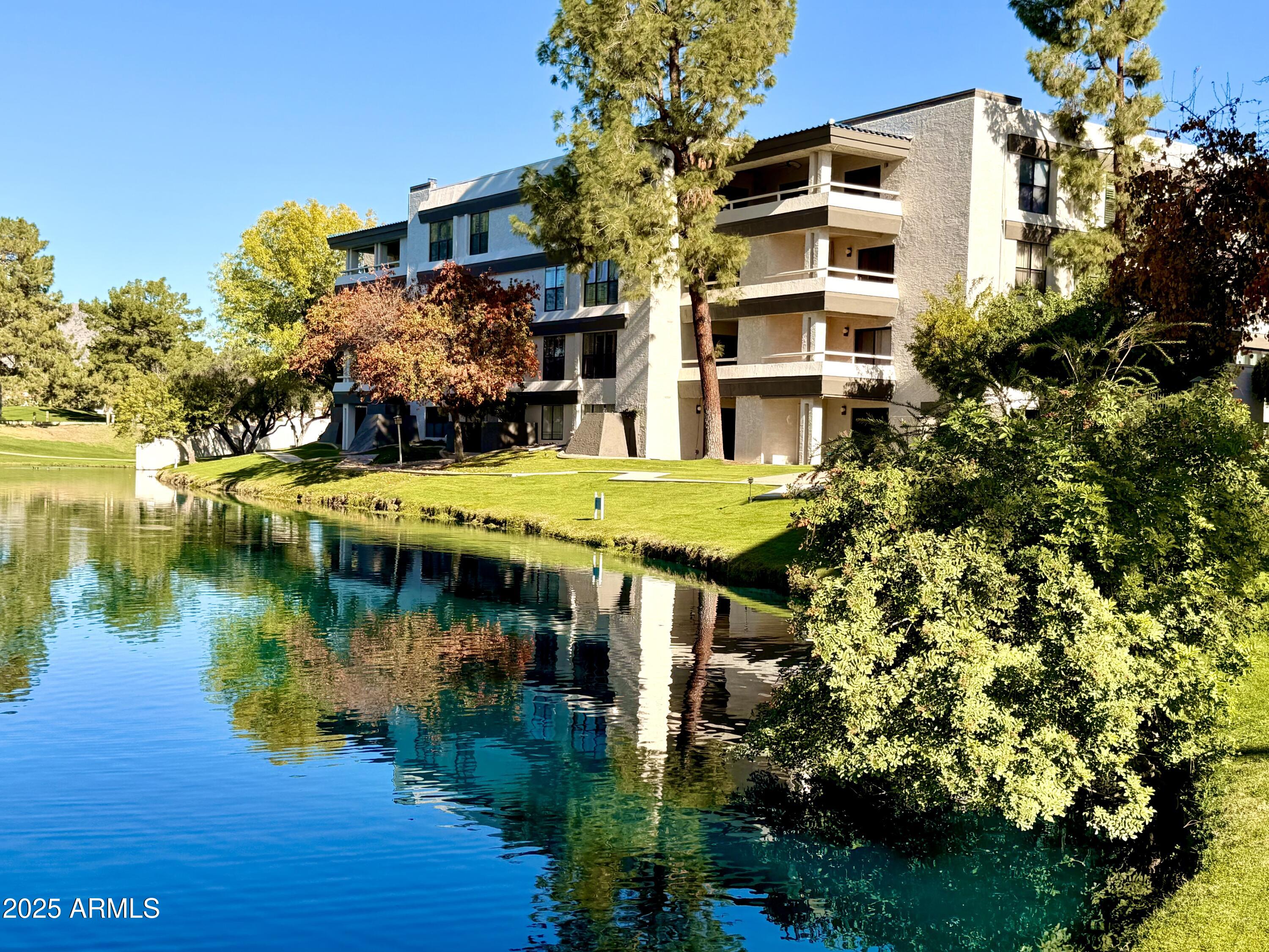 a aerial view of a house with swimming pool and lake view