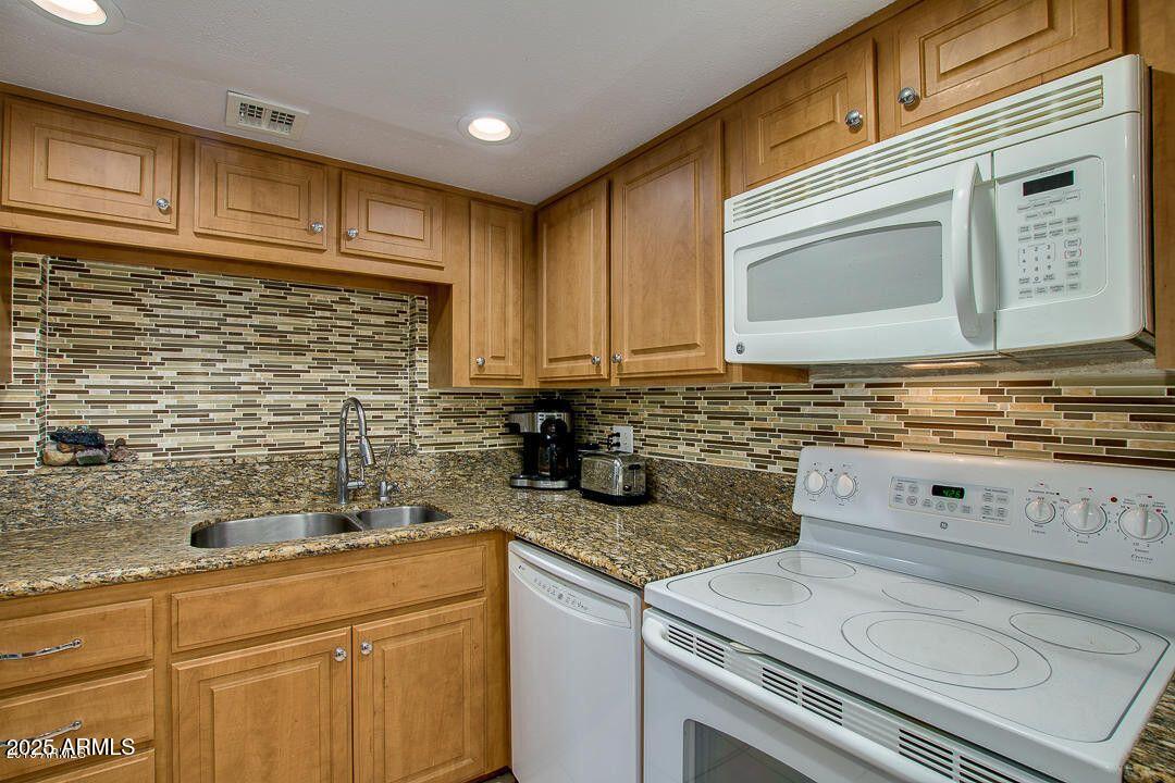 5136 North 31st Place, Unit 634 Phoenix, AZ 85016 - Photo 13 of 45 a kitchen with stainless steel appliances granite countertop a sink and cabinets