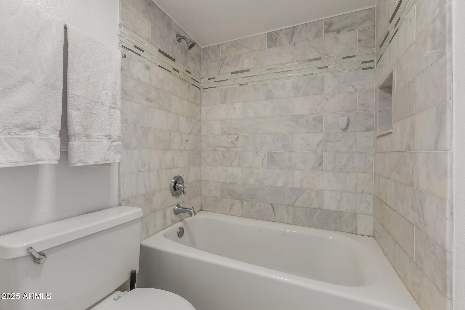 5136 North 31st Place, Unit 634 Phoenix, AZ 85016 - Photo 17 of 45 a white bath tub sitting next to a white toilet and sink