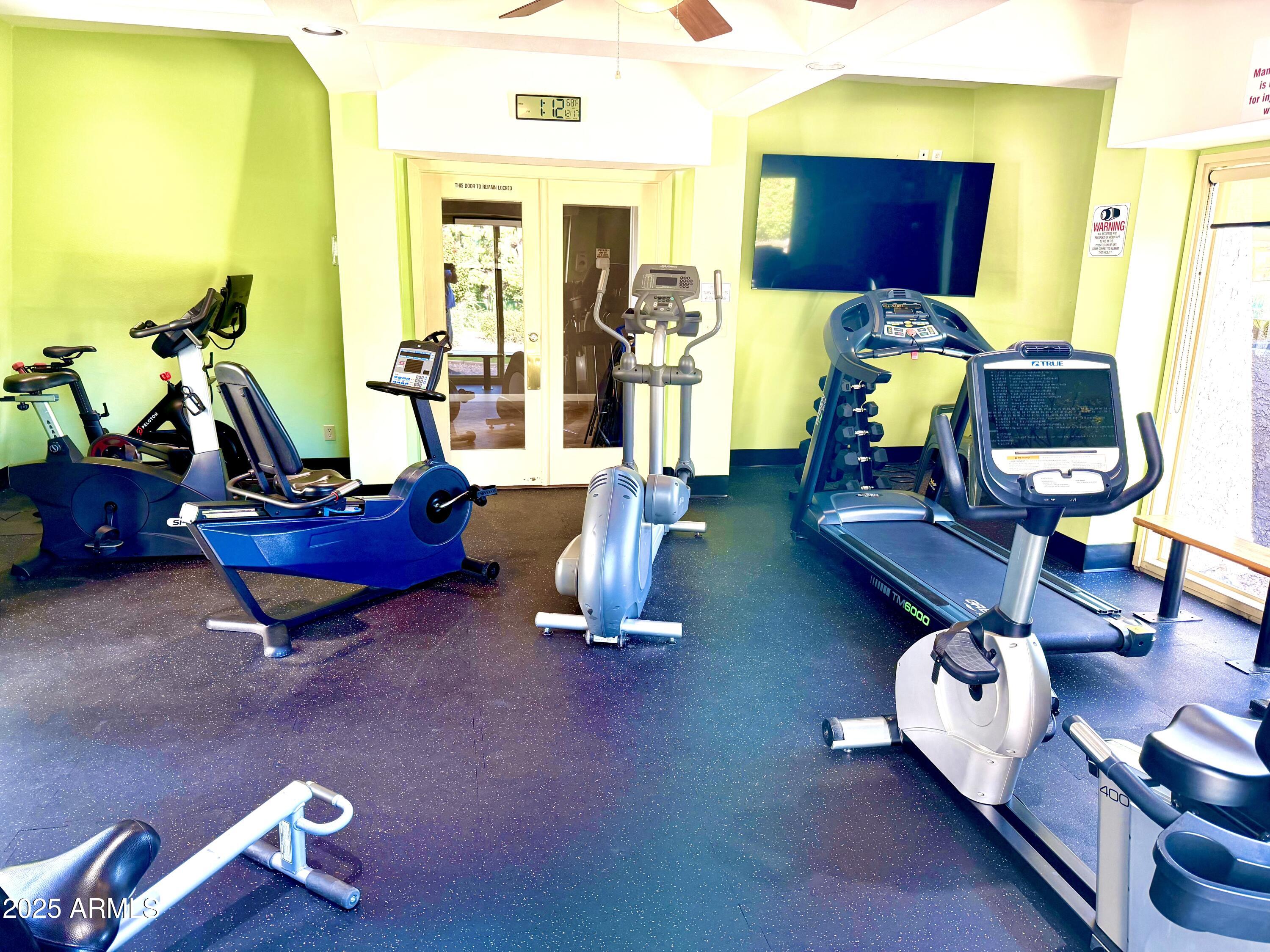 5136 North 31st Place, Unit 634 Phoenix, AZ 85016 - Photo 43 of 45 a living room with furniture pool table and a flat screen tv