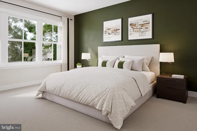 a large bed sitting in a bedroom next to a window