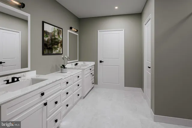 a spacious bathroom with a double vanity sink mirror and bathtub