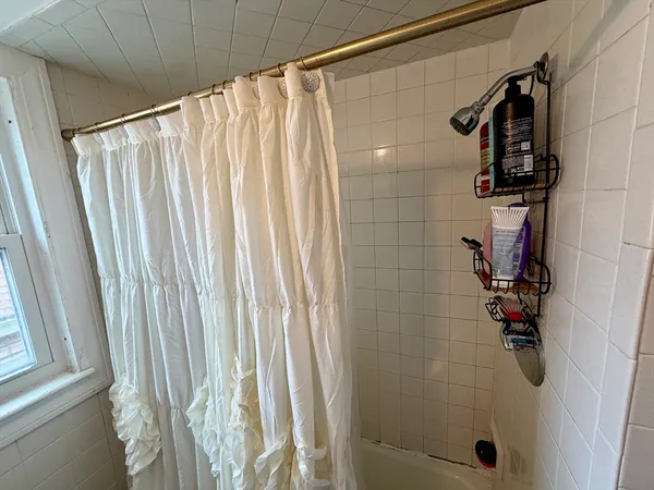 a bathroom with a shower and a tub
