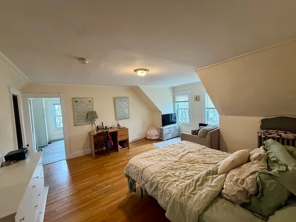 a bed room with a bed and wooden floor