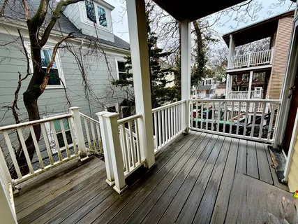 a view of balcony with wooden floor