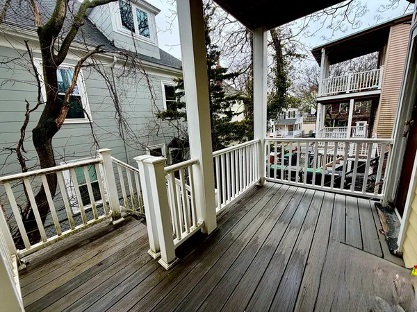 a view of balcony with wooden floor