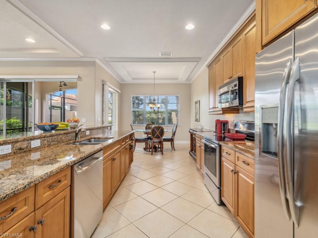 a kitchen with stainless steel appliances granite countertop a refrigerator and a sink