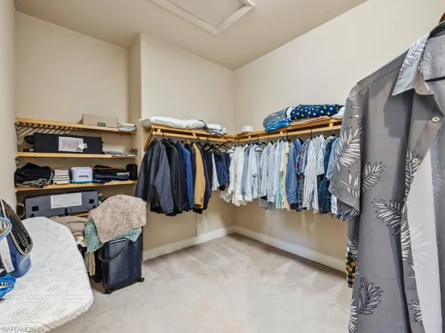 a view of walk in closet with clothes and shoes