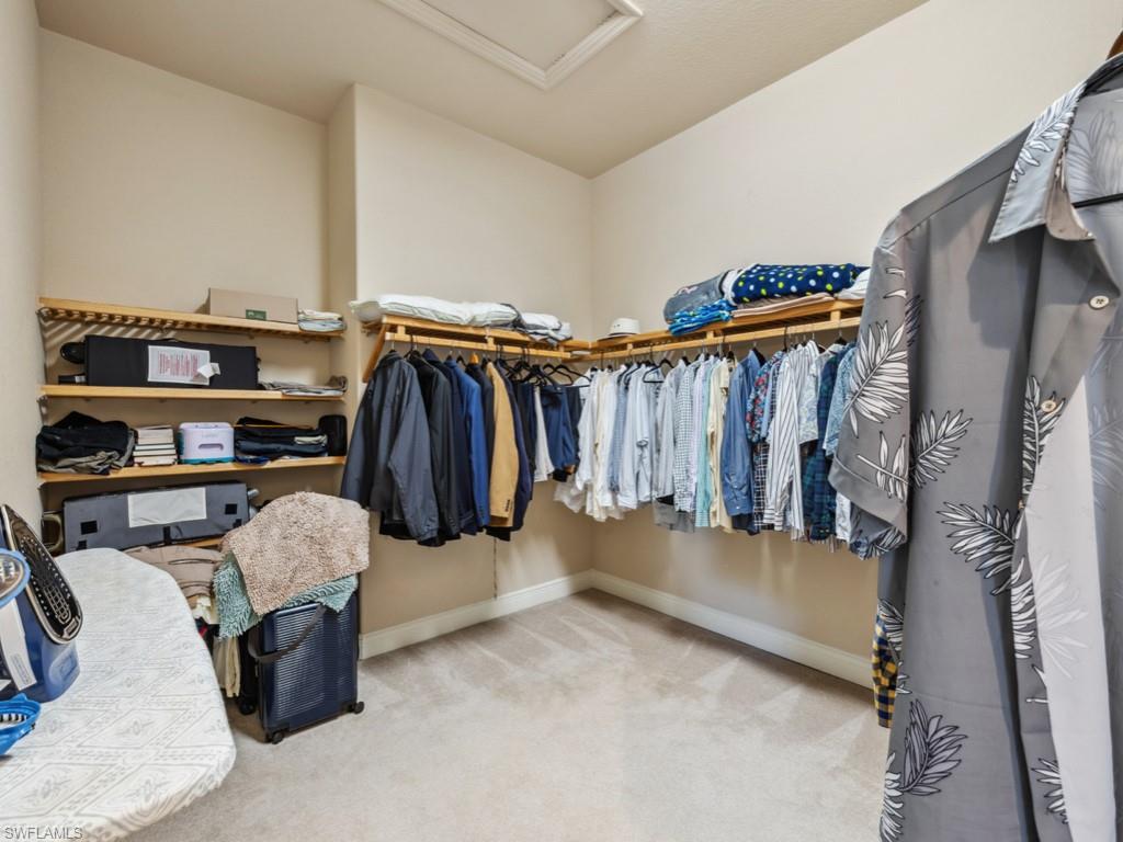 5705 Mango Circle Naples, FL 34110 - Photo 11 of 48 a view of walk in closet with clothes and shoes
