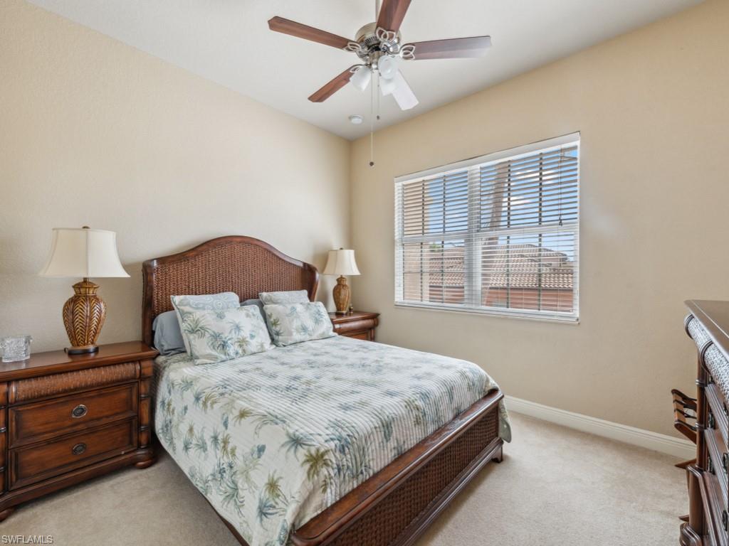 5705 Mango Circle Naples, FL 34110 - Photo 12 of 48 a bedroom with a large bed and a window
