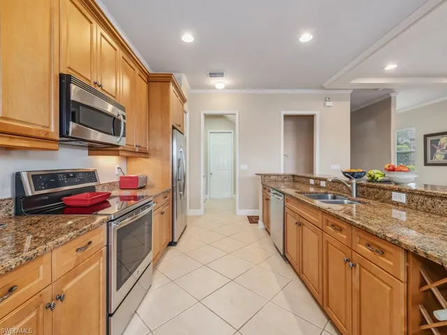 a large kitchen with stainless steel appliances granite countertop a stove and cabinets