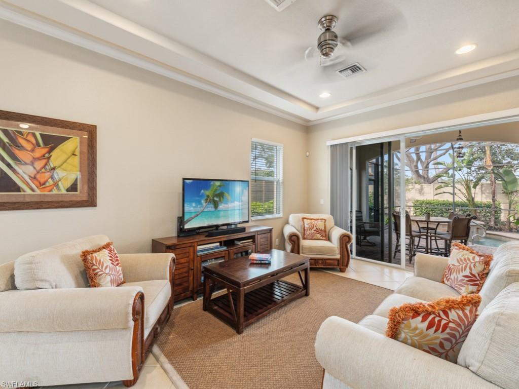 5705 Mango Circle Naples, FL 34110 - Photo 5 of 48 a living room with furniture and a flat screen tv