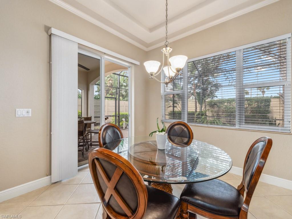 5705 Mango Circle Naples, FL 34110 - Photo 7 of 48 a view of a dining room with furniture wooden floor and chandelier