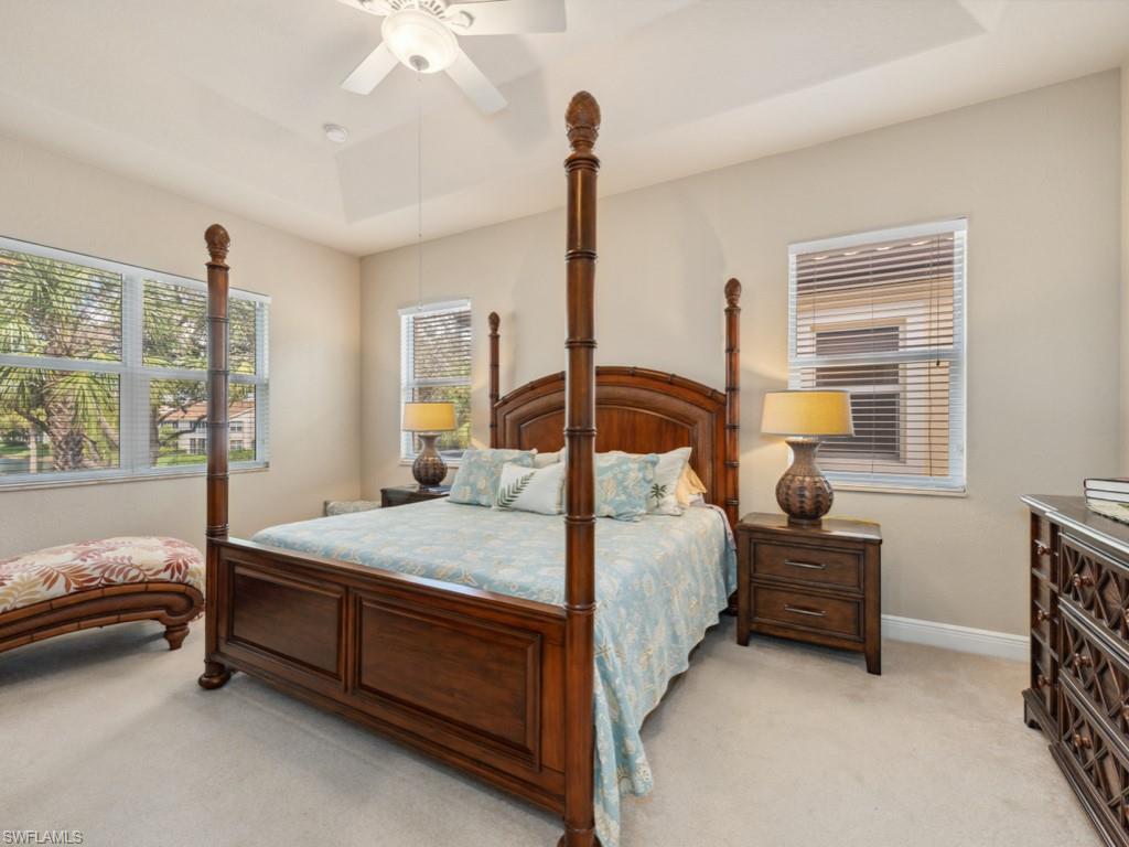 5705 Mango Circle Naples, FL 34110 - Photo 8 of 48 a bedroom with a bed and a chandelier