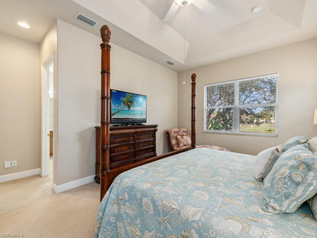 5705 Mango Circle Naples, FL 34110 - Photo 9 of 48 a bedroom with a bed and a flat screen tv