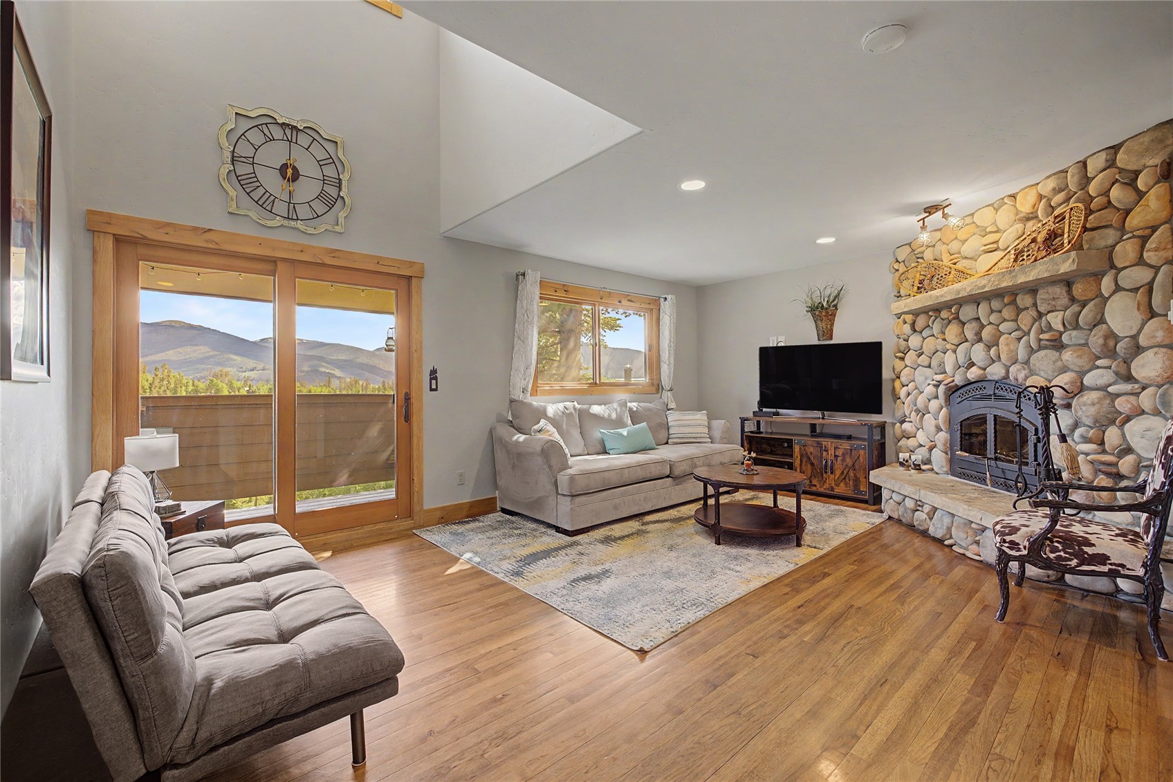 6726 Ryan Gulch Road, Unit 6726 Wildernest, CO 80498 - Photo 1 of 39 a living room with furniture a flat screen tv and a large window