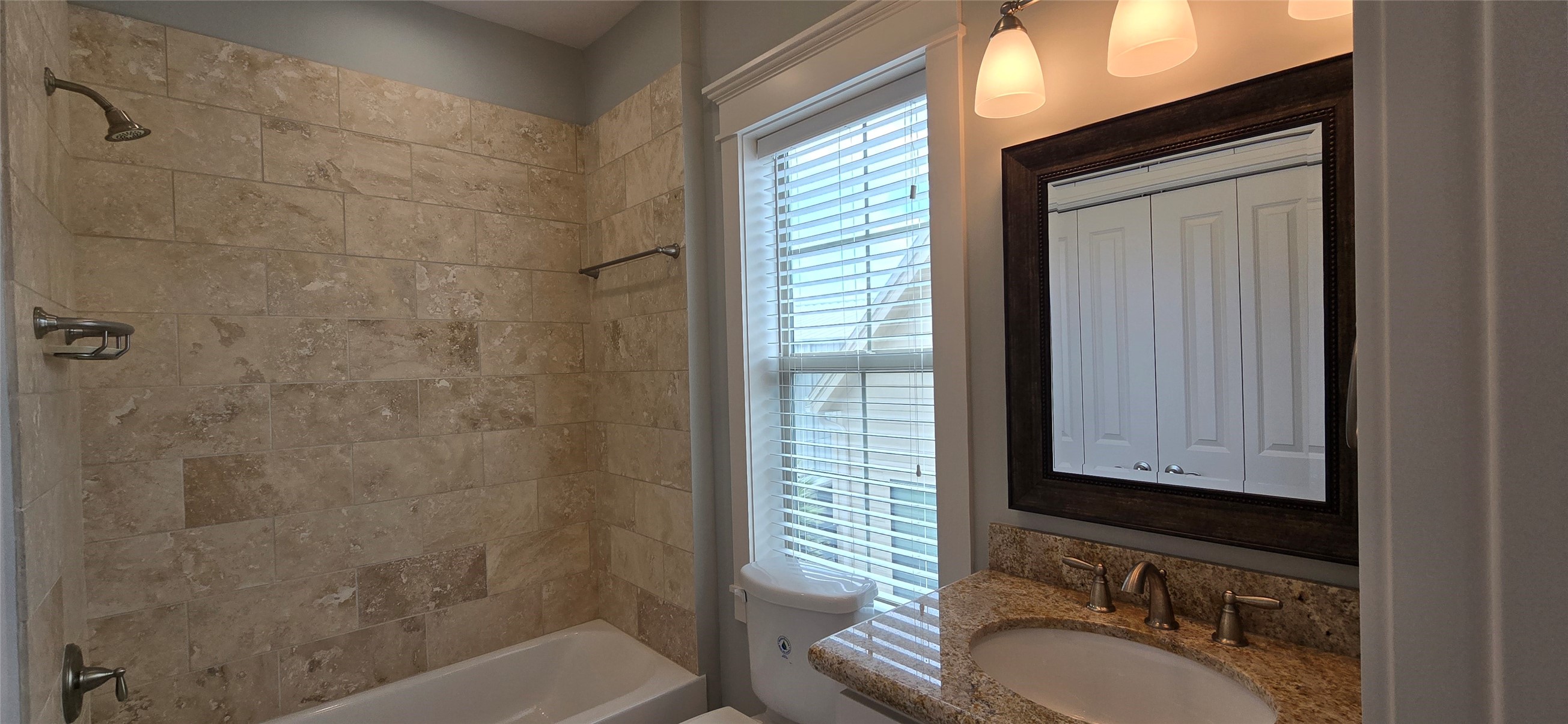 1117 Bonner Street Houston, TX 77007 - Photo 27 of 44 The en-suite full bathroom includes a tub/shower combo with neutral colored ceramic tiling and a nice window to bring in natural light.