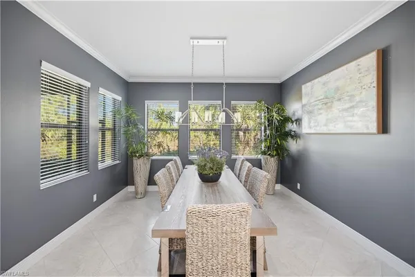 a bedroom with a large bed and a potted plant