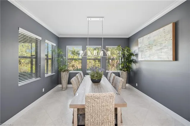 a bedroom with a large bed and a potted plant